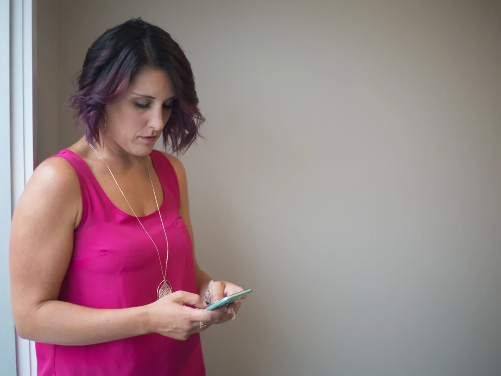 A person using a smartphone, illustrating mobile connectivity abroad